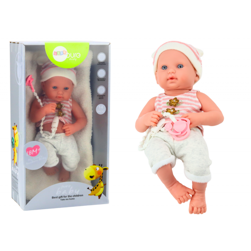 Baby doll in white and pink clothes, hat, pacifier, and blanket