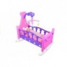 Rocking bed with doll and bedding mobile included